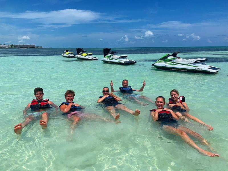 Guests relaxing in shallow water on a jet ski tour