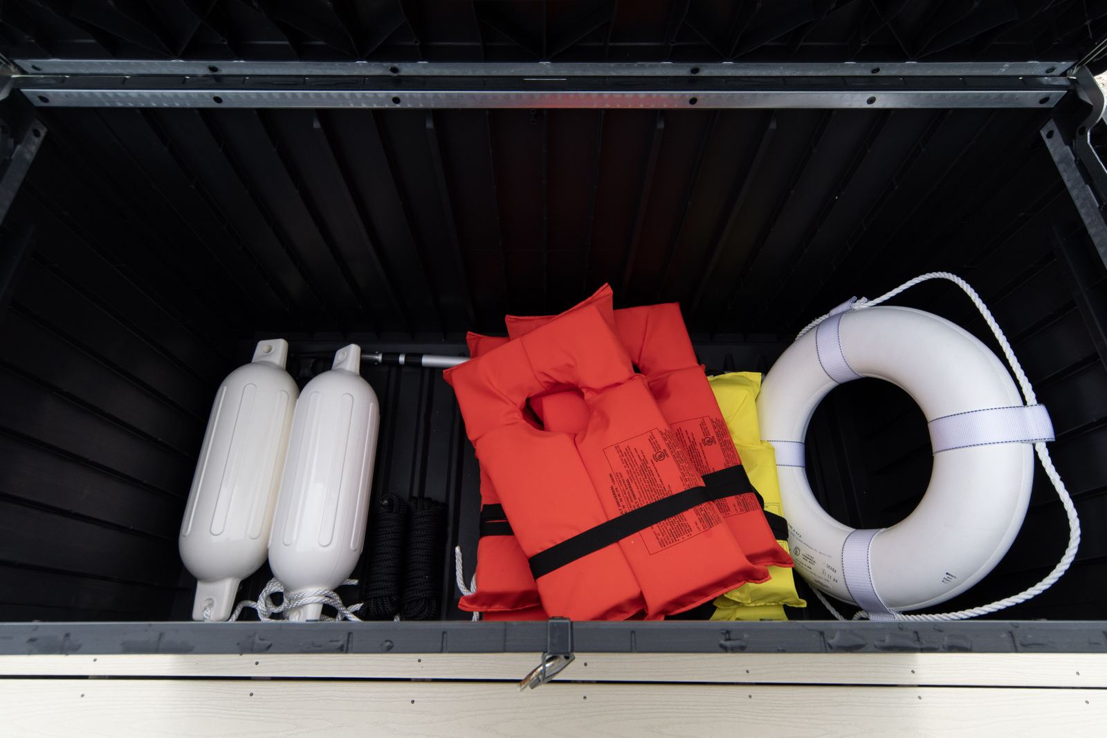 Dock box with life jackets, fenders and a life ring