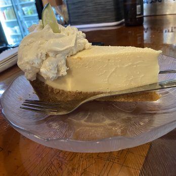 A slice of key lime pie topped with whipped cream