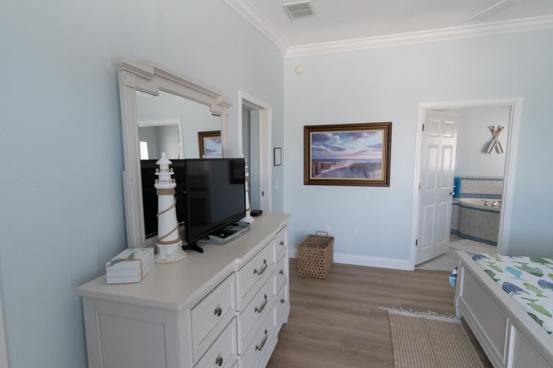 Master suite dresser and TV, with the bathroom beyond