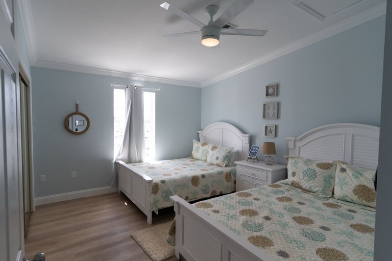 Bedroom with two queen beds and coastal decor