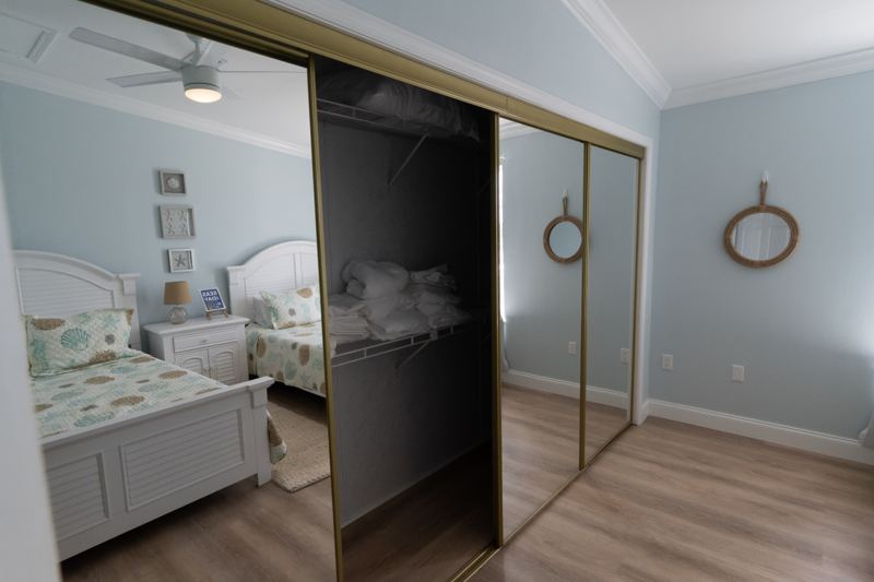 Double queen bedroom with a mirrored closet