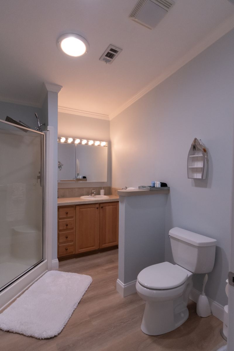 Bathroom with a walk-in shower beside the double queen bedroom